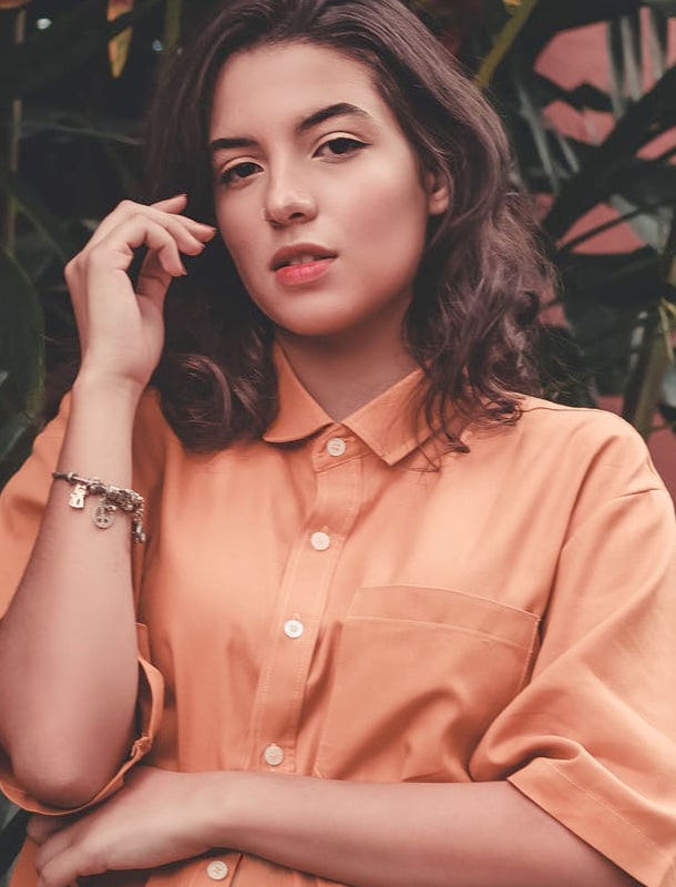 model posing with peach shirt